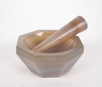 a bowl with a mortar and a pestor in it