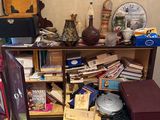a small cabinet with a bunch of books on top of it