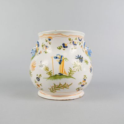 a white vase with a blue and yellow design on it