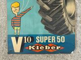 a sign with a picture of a boy flying a kite