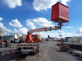 a red crane that is sitting in the middle of a parking lot
