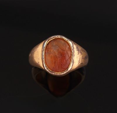 une bague en or avec une pierre de cornaline au centre