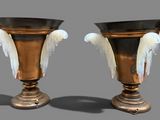 two vases with white wings on them on a gray background