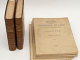 two old books sitting on top of each other next to each other