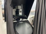 une photo en noir et blanc d'un téléviseur dans une pièce avec des rideaux