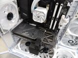 a close up of a computer case with a fan and a hard drive