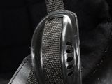 a close up of a black helmet with a metal buckle