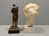 two statues of a man and a woman standing next to each other