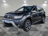 the grey dacia is parked in a large room with a checkered floor