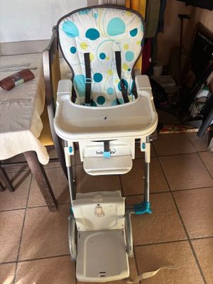 a baby high chair that is sitting on the floor