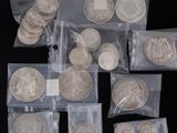 some silver coins are sitting in a bag on a black surface