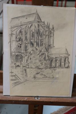 a drawing of a church on a easel in a room