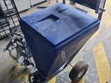 a blue cart sitting on the floor in a garage