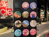 a display of buttons on a black rack in a store