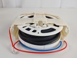un gros plan d'une bobine de film posée sur une surface blanche