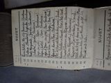an old book with writing on it sitting on a table