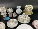 many different types of porcelain dishes and cups on the table