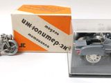 a small model of a motorcycle and a small model of a car in a box