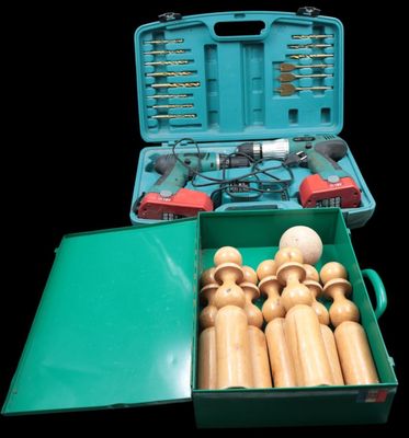 a green box with a bunch of wooden toys inside of it