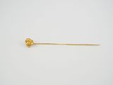 an image of a gold stick with a flower on it