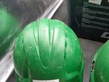 two green hard hats sitting on top of a table