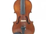 an old violin sitting on a white surface with a white background