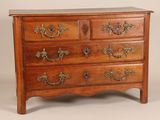 a wooden chest of drawers with many drawers on it