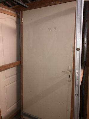 a white door in a room that is being built