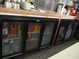 many bottles of drinks in the fridges in the kitchen