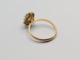 a close up of a gold ring on a white surface