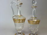 two glass vases sitting next to each other on a table