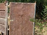 an old rusted out gate in the middle of a field
