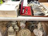 many plates and bowls on a shelf in a store