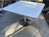 a white table that is sitting in the back of a truck