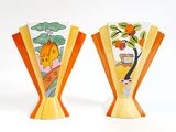 two vases that have been painted with oranges on them