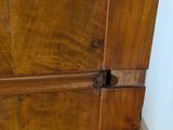a wooden cabinet with a door that has a latch on it