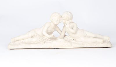 a statue of two children laying on the ground