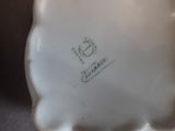 a close up of a white plate with a clock on it