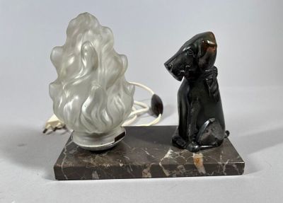 a statue of a woman sitting next to a lamp