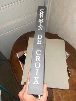 a person holding a book that is on a table