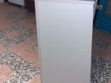 a white counter with a blue door in the background