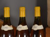 three bottles of wine are lined up on a table