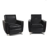pair of black leather club chairs with chrome legs