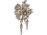 a close up of a brooch with pearls on it