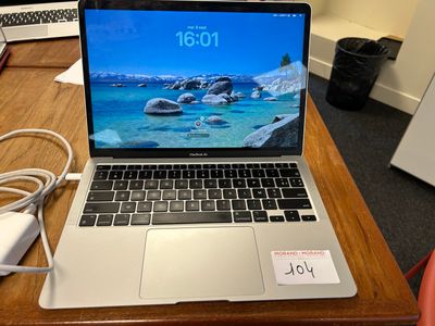 a laptop that is sitting on a desk with a charger
