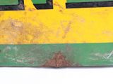 a yellow and green sign on the wall of a building