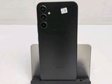 the back of a black phone is sitting on a stand