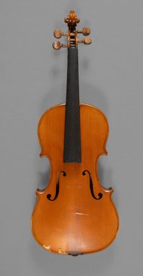 a close up of a violin on a gray surface