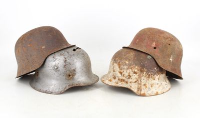 two helmets sitting next to each other on a white surface