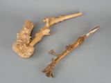two pieces of root and a stick on a table